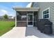 The screened-in porch offers outdoor seating space with a grill located on the concrete patio at 1214 Valley Dale Dr, Fuquay Varina, NC 27526