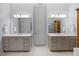 Bathroom with double vanity sinks, large mirrors, and ample cabinet space at 122 Glenpark Pl, Cary, NC 27511