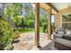 Spacious covered patio with stone flooring, elegant columns, and views of the manicured backyard at 122 Glenpark Pl, Cary, NC 27511