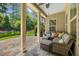 Relaxing covered patio with comfortable seating, fan, and stone flooring; perfect for outdoor lounging at 122 Glenpark Pl, Cary, NC 27511