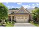 Charming brick home showcasing a well-manicured lawn and attached two car garage at 122 Glenpark Pl, Cary, NC 27511