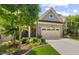 Home showcasing a brick facade, attached two-car garage, manicured landscaping at 122 Glenpark Pl, Cary, NC 27511