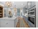 Kitchen featuring stainless steel appliances, gray cabinets, and a center island at 122 Glenpark Pl, Cary, NC 27511