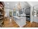 Kitchen offers wood floors, granite counters, stainless appliances, gray cabinets, and center island at 122 Glenpark Pl, Cary, NC 27511