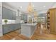 Kitchen boasting gray cabinets, center island, stainless steel appliances, and modern lighting at 122 Glenpark Pl, Cary, NC 27511