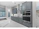 The open kitchen features stainless steel appliances, gray cabinets, and a center island at 122 Glenpark Pl, Cary, NC 27511