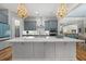 A spacious kitchen features an oversized island, stainless appliances, and decorative pendant lighting at 122 Glenpark Pl, Cary, NC 27511