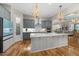 A spacious kitchen features an oversized island, stainless appliances, and decorative pendant lighting at 122 Glenpark Pl, Cary, NC 27511