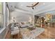 Bright living room features a decorative ceiling fan, hardwood floors, and a colorful area rug at 122 Glenpark Pl, Cary, NC 27511