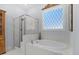 Luxurious bathroom boasts a glass shower and a soaking tub by a bright window at 122 Glenpark Pl, Cary, NC 27511