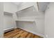 Walk-in closet with wooden floors and built-in shelving at 122 Glenpark Pl, Cary, NC 27511