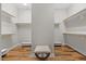 Spacious walk-in closet with built-in shelving and wood flooring at 122 Glenpark Pl, Cary, NC 27511