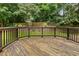 An aged wooden deck provides a serene place to relax and enjoy the backyard at 12620 Waterlow Park Ln, Raleigh, NC 27614