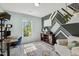 Well lit bedroom with a workstation, stylish accent wall and natural lighting at 12620 Waterlow Park Ln, Raleigh, NC 27614