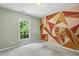 Bedroom with colorful geometric wall art, window with green views and neutral carpet, perfect for  at 12620 Waterlow Park Ln, Raleigh, NC 27614