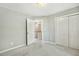 Bright bedroom with modern carpeting, closet, and an open door leading to the upper level at 12620 Waterlow Park Ln, Raleigh, NC 27614