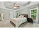 Bedroom with neutral color palette and large windows overlooking a green outdoor view at 12620 Waterlow Park Ln, Raleigh, NC 27614