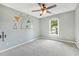 bedroom with a modern paint scheme, window with exterior views and neutral colored carpet at 12620 Waterlow Park Ln, Raleigh, NC 27614