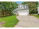 Charming two-story home with gray siding, black shutters, and an attached two-car garage at 12620 Waterlow Park Ln, Raleigh, NC 27614