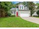 Charming two-story home with gray siding, black shutters, and an attached two-car garage at 12620 Waterlow Park Ln, Raleigh, NC 27614