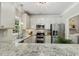 Bright kitchen featuring granite countertops, stainless steel appliances, and ample cabinet space at 12620 Waterlow Park Ln, Raleigh, NC 27614