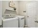 Practical laundry room featuring modern washer and dryer units, with a clean and organized space at 12620 Waterlow Park Ln, Raleigh, NC 27614