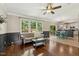 Inviting living room boasts hardwood floors, wainscoting, and natural light at 12620 Waterlow Park Ln, Raleigh, NC 27614