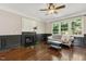 Cozy living room featuring a fireplace and a large window overlooking the backyard at 12620 Waterlow Park Ln, Raleigh, NC 27614