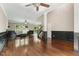Spacious living room with hardwood floors, a ceiling fan, and decorative wall trim at 12620 Waterlow Park Ln, Raleigh, NC 27614