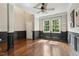 Bright living room featuring hardwood floors, a ceiling fan, and decorative wall trim at 12620 Waterlow Park Ln, Raleigh, NC 27614