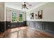 Bright living room featuring hardwood floors, a ceiling fan, and decorative wall trim at 12620 Waterlow Park Ln, Raleigh, NC 27614