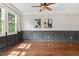 Bright living room featuring hardwood floors, a ceiling fan, and decorative wall trim at 12620 Waterlow Park Ln, Raleigh, NC 27614