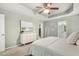 Spacious main bedroom featuring tray ceiling, modern furnishings and an attached ensuite bath and closet at 12620 Waterlow Park Ln, Raleigh, NC 27614