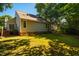 A well maintained backyard with mature trees and a brick foundation at 13 Boxwood Dr, Durham, NC 27713