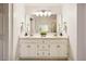 Double vanity bathroom featuring large framed mirror and contemporary lighting at 13 Boxwood Dr, Durham, NC 27713