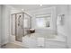Bright and airy bathroom featuring separate glass shower and soaking tub with window at 13 Boxwood Dr, Durham, NC 27713