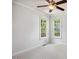 Bright bedroom with ceiling fan, two windows, and neutral carpet, creating a peaceful and inviting space at 13 Boxwood Dr, Durham, NC 27713