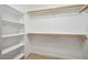 Spacious walk-in closet featuring built-in shelving and two levels of hanging rods at 13 Boxwood Dr, Durham, NC 27713