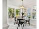 Inviting dining area features a glass table, black chairs, and a sliding door to the outdoor deck at 13 Boxwood Dr, Durham, NC 27713
