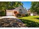 Inviting single-story home with a red front door, attached garage, and lush front lawn at 13 Boxwood Dr, Durham, NC 27713