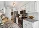 Modern kitchen boasts stainless steel appliances, granite countertops, and white cabinetry, maximizing space and efficiency at 13 Boxwood Dr, Durham, NC 27713
