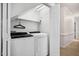 Efficient laundry room with washer, dryer, and shelving, providing convenient space for laundry tasks at 13 Boxwood Dr, Durham, NC 27713
