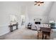 Spacious living room featuring vaulted ceilings, large windows, a fireplace, and an open-concept design at 13 Boxwood Dr, Durham, NC 27713