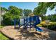 Community playground with a slide, climbing wall and swings at 13 Boxwood Dr, Durham, NC 27713