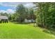 Spacious, well-maintained backyard featuring lush grass, a border of trees, and a fenced perimeter at 131 Abacos Ct, Clayton, NC 27520
