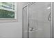 Bright bathroom featuring a walk-in shower with glass door and a window for natural light at 131 Abacos Ct, Clayton, NC 27520