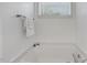 A bright bathroom with a window and towel rack above the bathtub at 131 Abacos Ct, Clayton, NC 27520