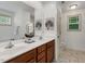 Bathroom features double sinks, a large mirror, and stylish tile flooring for a modern look at 131 Abacos Ct, Clayton, NC 27520