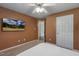 A cozy carpeted bedroom with a ceiling fan and wall-mounted tv at 131 Abacos Ct, Clayton, NC 27520