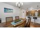 Open dining room featuring a wood table, chandelier, and view of the kitchen area at 131 Abacos Ct, Clayton, NC 27520
